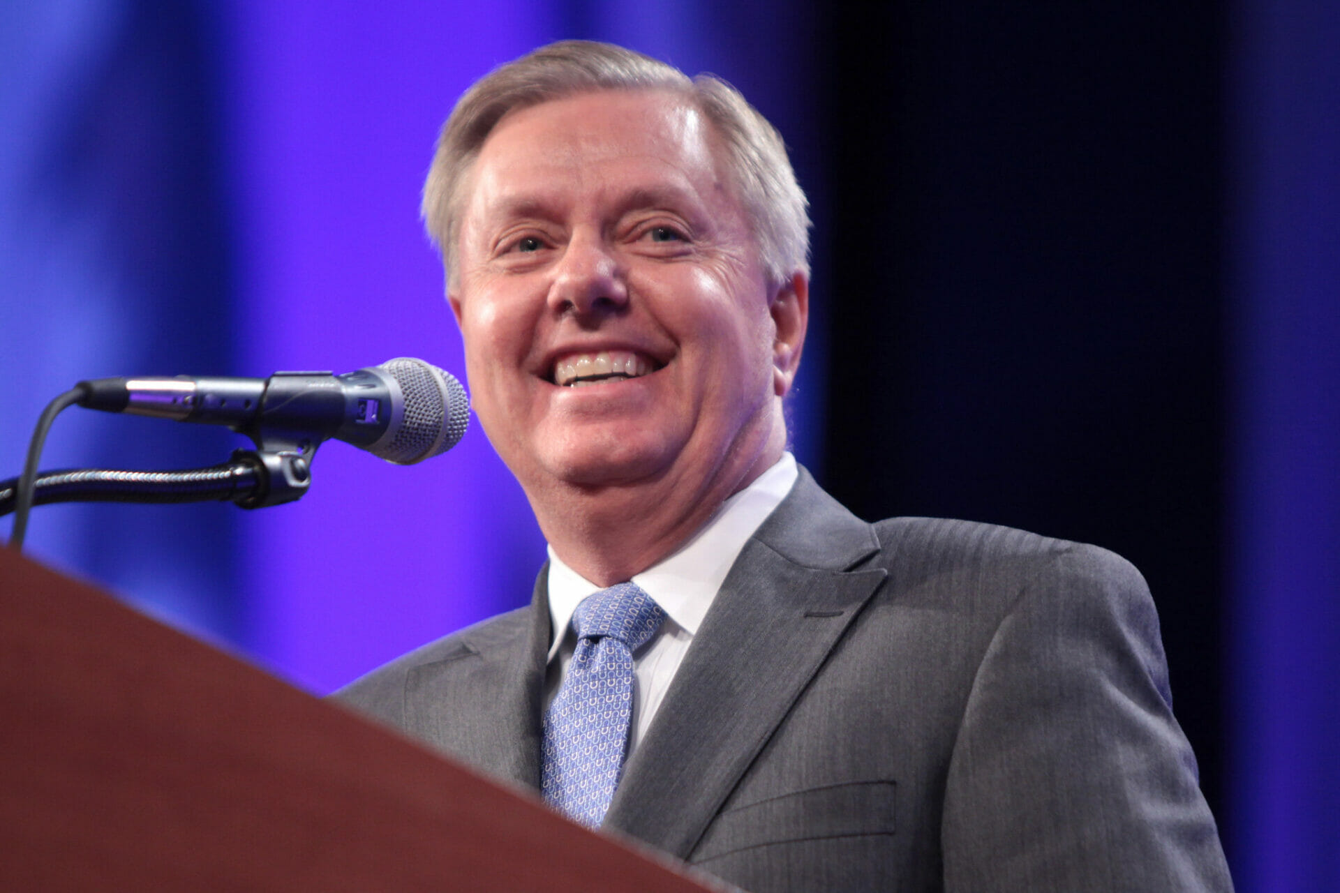 Senator Lindsey Graham speaking at a podium during a public event