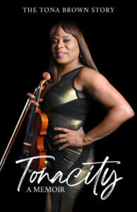 Tonacity Book _Front (1) | GLAAD Black backdrop with text on the top over the book cover: "Tonacity: the Tona Brown Story" Tona Brown is featured holding a violin with another hand on her left hip. She has black skin, light brown hair and is wearing a greenish/gold metallic dress with Black fabric woven in at the rib cage.