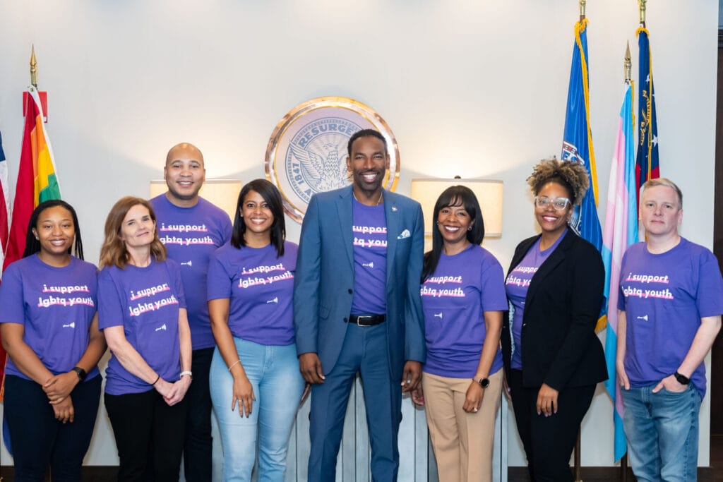 Spirit Day photo at the Mayor's Office. Malik Brown (he/him), Director, Mayor's Divison of LGBTQ Affairs & Mayor Andre Dickens.