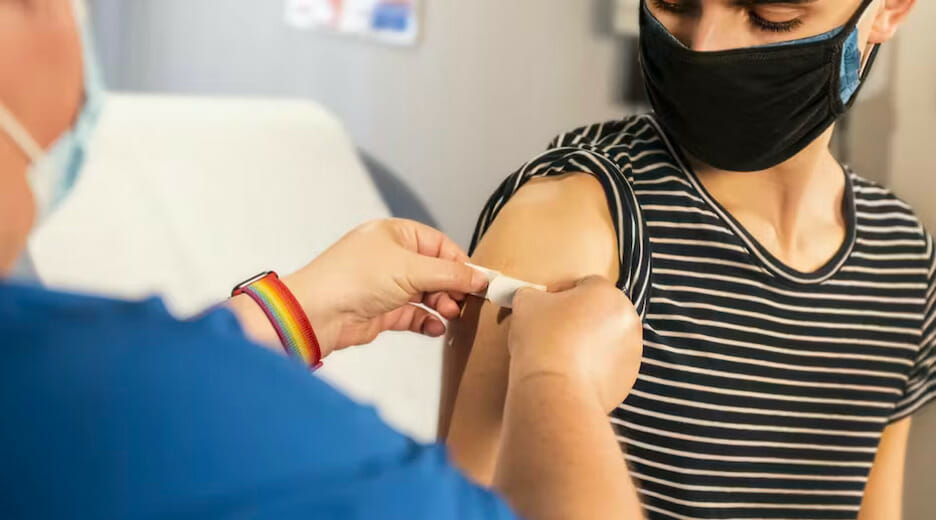 Person getting a shot. Photo via Unsplash