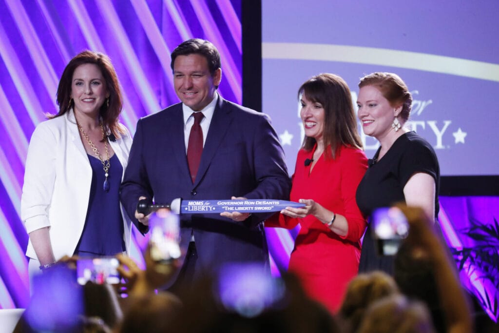 Moms for Liberty's co-founders pose with Florida Gov. Ron DeSantis