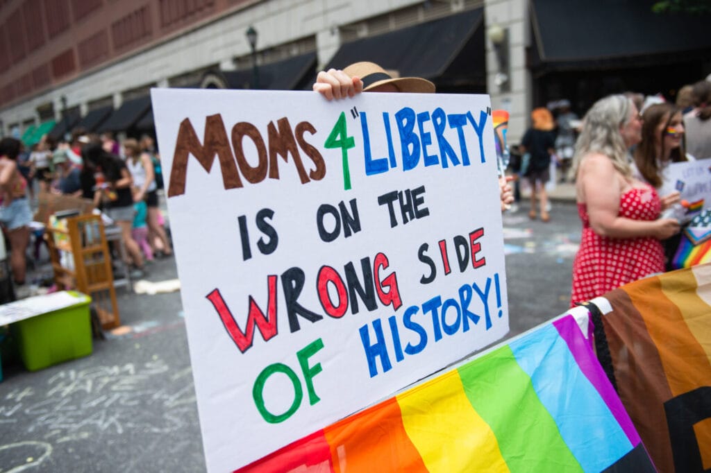 A protester holds a placard during a protest against Moms for Liberty’s 2023 national summit in Philadelphia, PA.