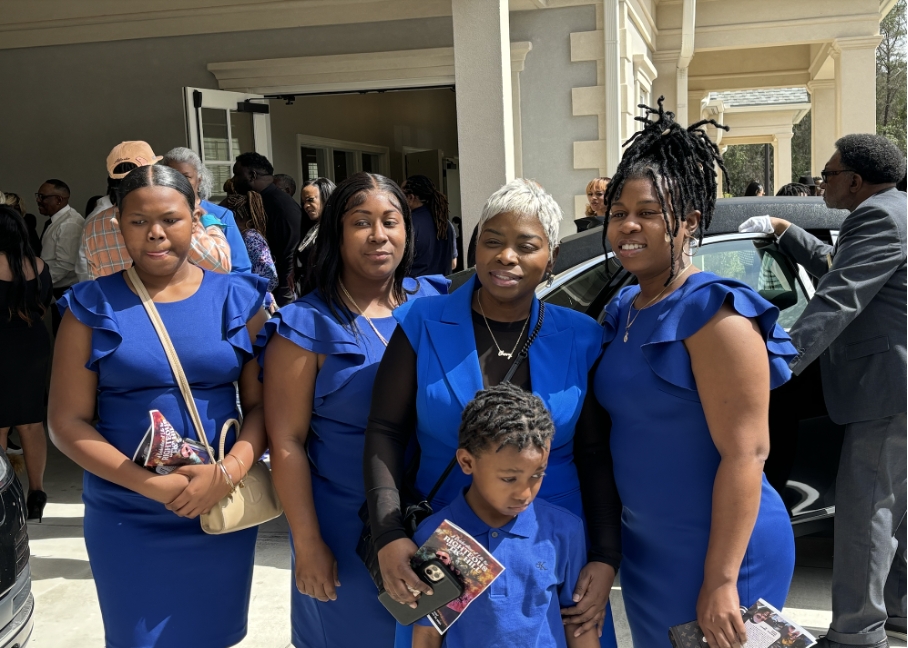 Article-03142024-Picture4 | GLAAD Terri Wilson (center), Hill’s partner, pictured with family following the funeral on March 11, 2024.