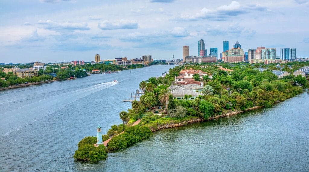 Tampa Bay, peninsula, green, surrounded by water with blue partly cloudy skies