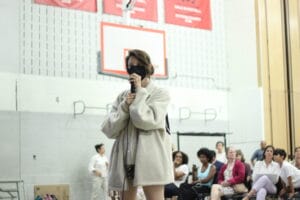 IMG_0003 | GLAAD Lex Bean, they/them, wite with brown hair tied up in a pony tail. They are wearing a cream colored, fluffy textured fleece that goes down to their thigh. They are wearing shorts and yellow leather combat boots.