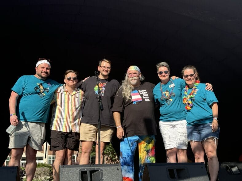 Renaissance City Pride Organizers (L to R): Jonathan Dunlap, Ash Campbell, Aaron Dean, Jim Manchester, Becca Moon, and Jennifer Larder pose for a photo at the Renaissance City Pride outdoor music festival in Wilson Park on June 8, 2024.