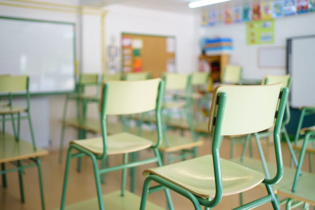Close-up of a chair on a student's desk inside a classroom in a secondary school.