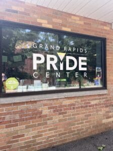 IMG_3892 | GLAAD Pale brick wall bordering a glass window with letter print reading "GRAND RAPIDS PRIDE CENTER"