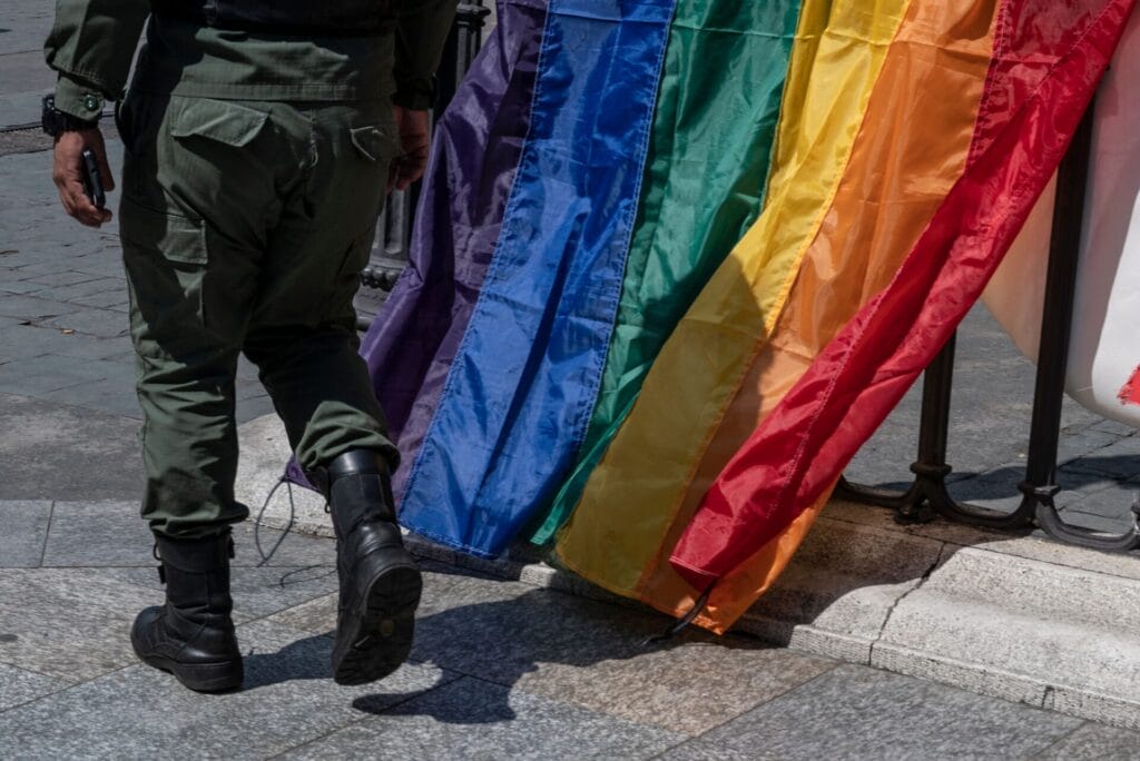 Military member near a LGBTQ flag