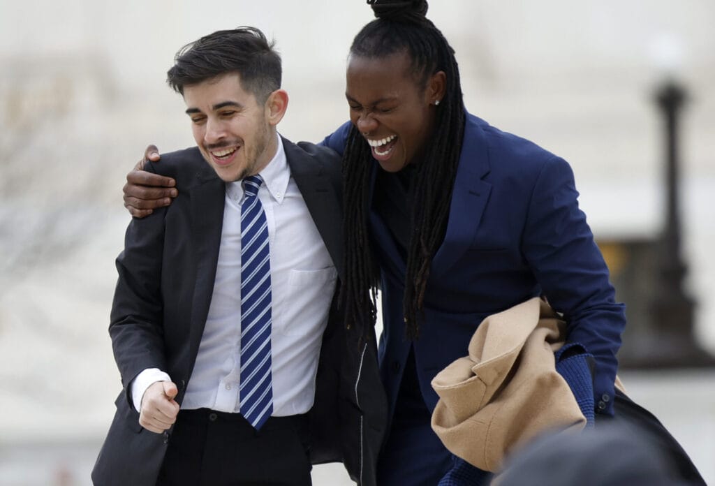 Chase Strangio and AJ Hikes of the American Civil Liberties Union celebrate outside the U.S. Supreme Court after oral arguments. | GLAAD Chase Strangio and AJ Hikes of the American Civil Liberties Union celebrate outside the U.S. Supreme Court after oral arguments.