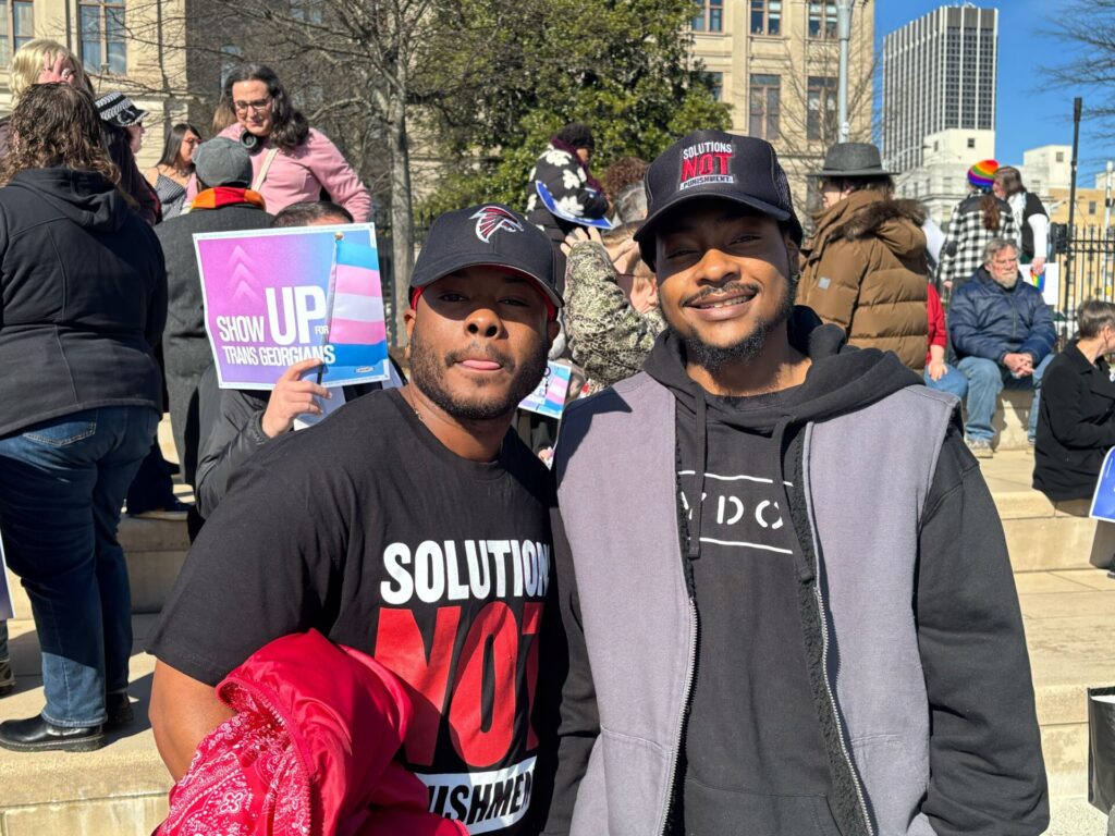 Dean Steed (left) and transgender recording artist 2AM Ricky (right) pose following the Stand Up for Trans Georgians Rally at Liberty Plaza on January 13, 2025, in Atlanta, Georgia. | GLAAD IMG_4408-Article-01142025