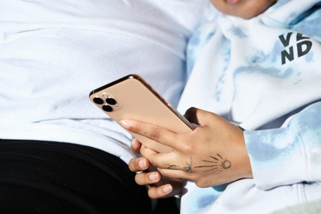 A trans couple looking at a cellphone in bed 8 | GLAAD A trans couple looking at a cellphone in bed 8