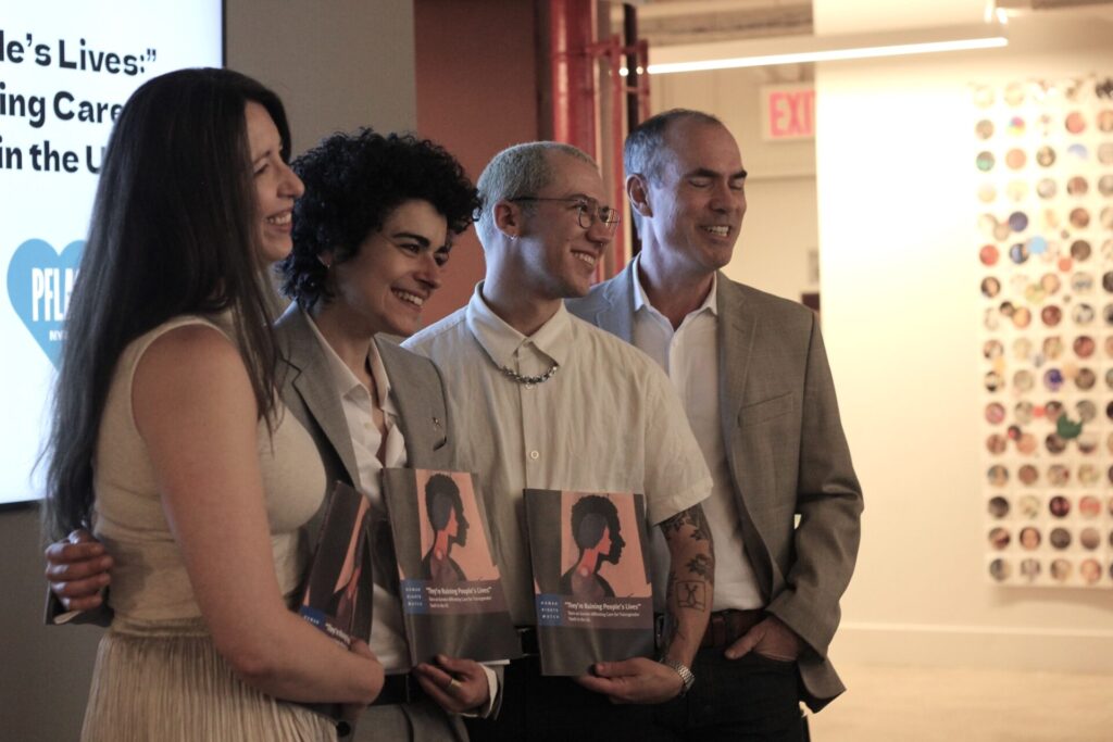 Human Rights Watch panelists pose for a photo | GLAAD Panelists stand up for a photo holding Human Rights Watch's new report "They're Ruining Our Lives"