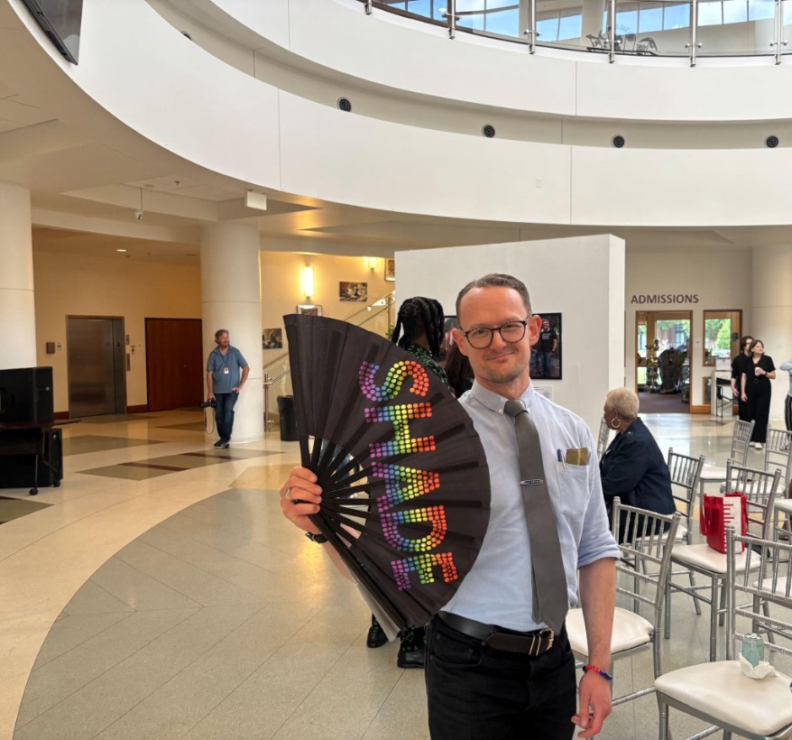 Dr. Thomas Bullington poses with a “Shade” fan before the start of Macon Pride’s Pioneer & Trailblazers Photo History Exhibit. | GLAAD Dr. Thomas Bullington poses with a “Shade” fan before the start of Macon Pride’s Pioneer & Trailblazers Photo History Exhibit.